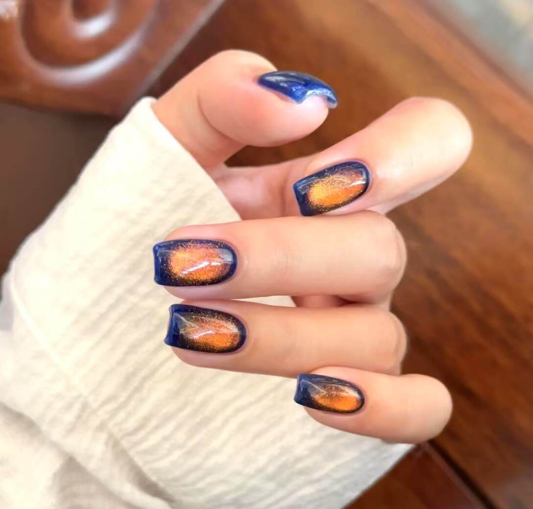 Fiery clouds magnetic cat eye gel polish creating a dramatic 3D nail effect with glowing red and orange shimmer, forming a radiant reflective cat eye line across the nail for a bold professional gel manicure inspired by fiery sunset clouds.