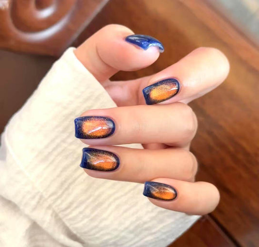 Fiery clouds magnetic cat eye gel polish creating a dramatic 3D nail effect with glowing red and orange shimmer, forming a radiant reflective cat eye line across the nail for a bold professional gel manicure inspired by fiery sunset clouds.