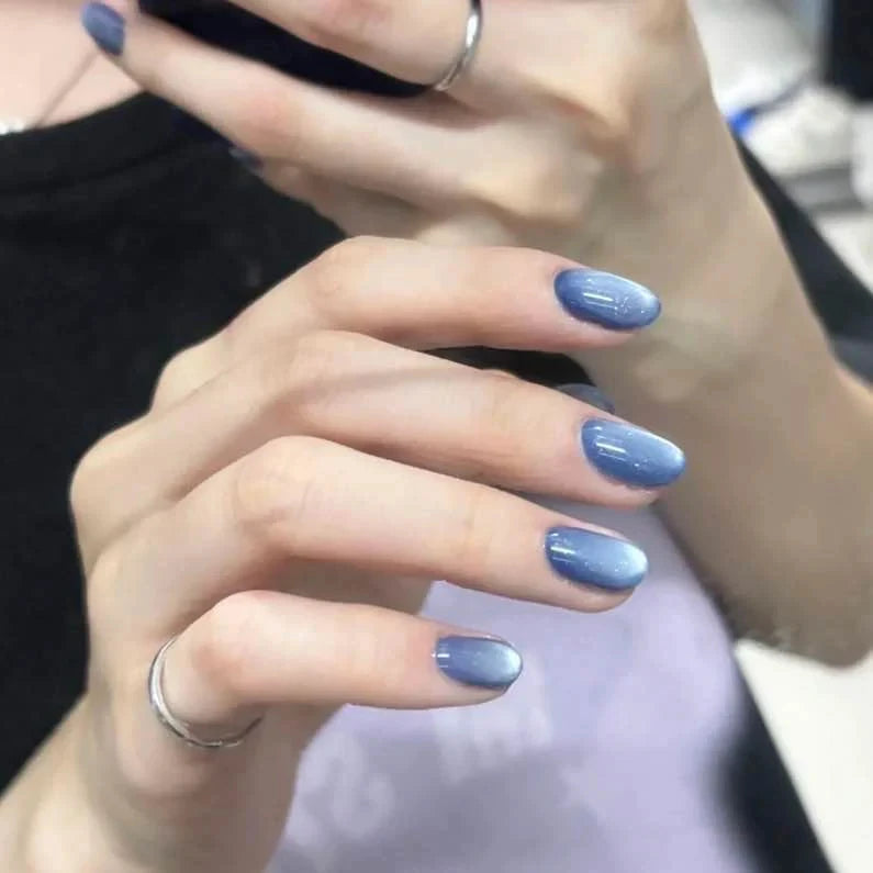 Heavenly body magnetic cat eye gel polish creating a celestial 3D nail effect with luminous shimmer and reflective particles, forming a glowing cat eye line across the nail for a dreamy professional gel manicure inspired by cosmic reflective nail design.