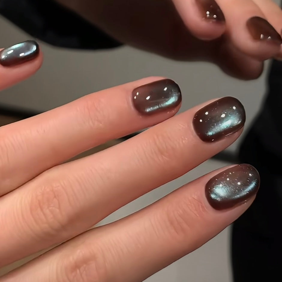 Mint chocolate brown magnetic cat eye gel polish creating a luxurious 3D nail effect with shimmering reflective particles, blending cool mint undertones with rich brown shimmer to form a striking reflective cat eye line for a professional gel manicure.