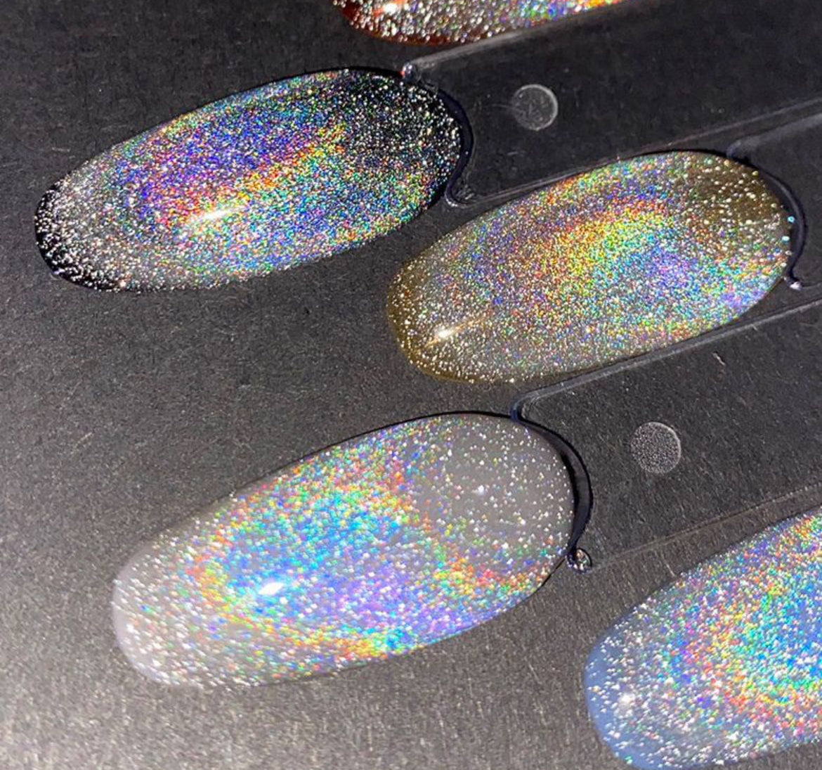 Rainbow magnetic cat eye gel polish creating a vibrant 3D nail effect with multicolor shimmer and reflective particles, forming a luminous cat eye line across the nail for a bold professional gel manicure and eye-catching reflective rainbow nail design.