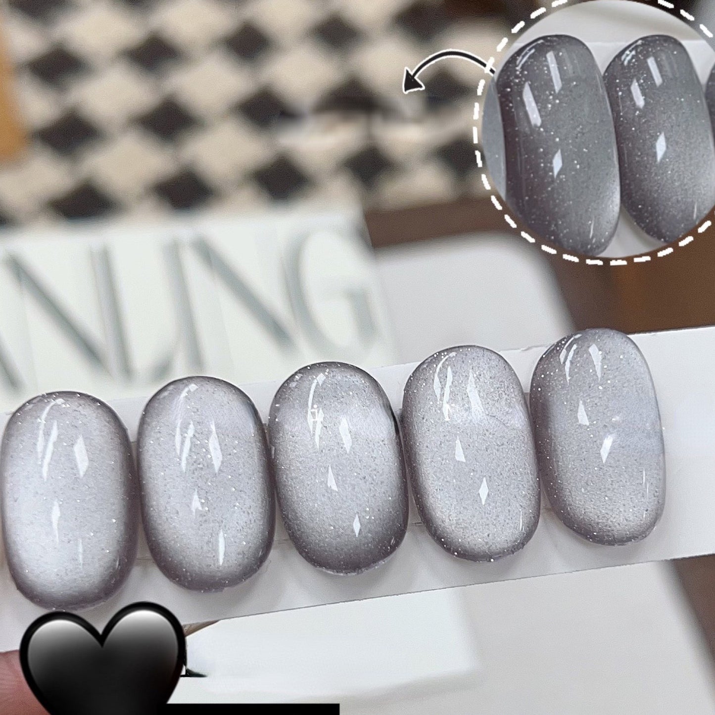 Storm magnetic cat eye gel polish creating a dramatic 3D nail effect with deep smoky shimmer and reflective particles, forming a mysterious glowing cat eye line across the nail for a bold professional gel manicure and striking reflective nail design.