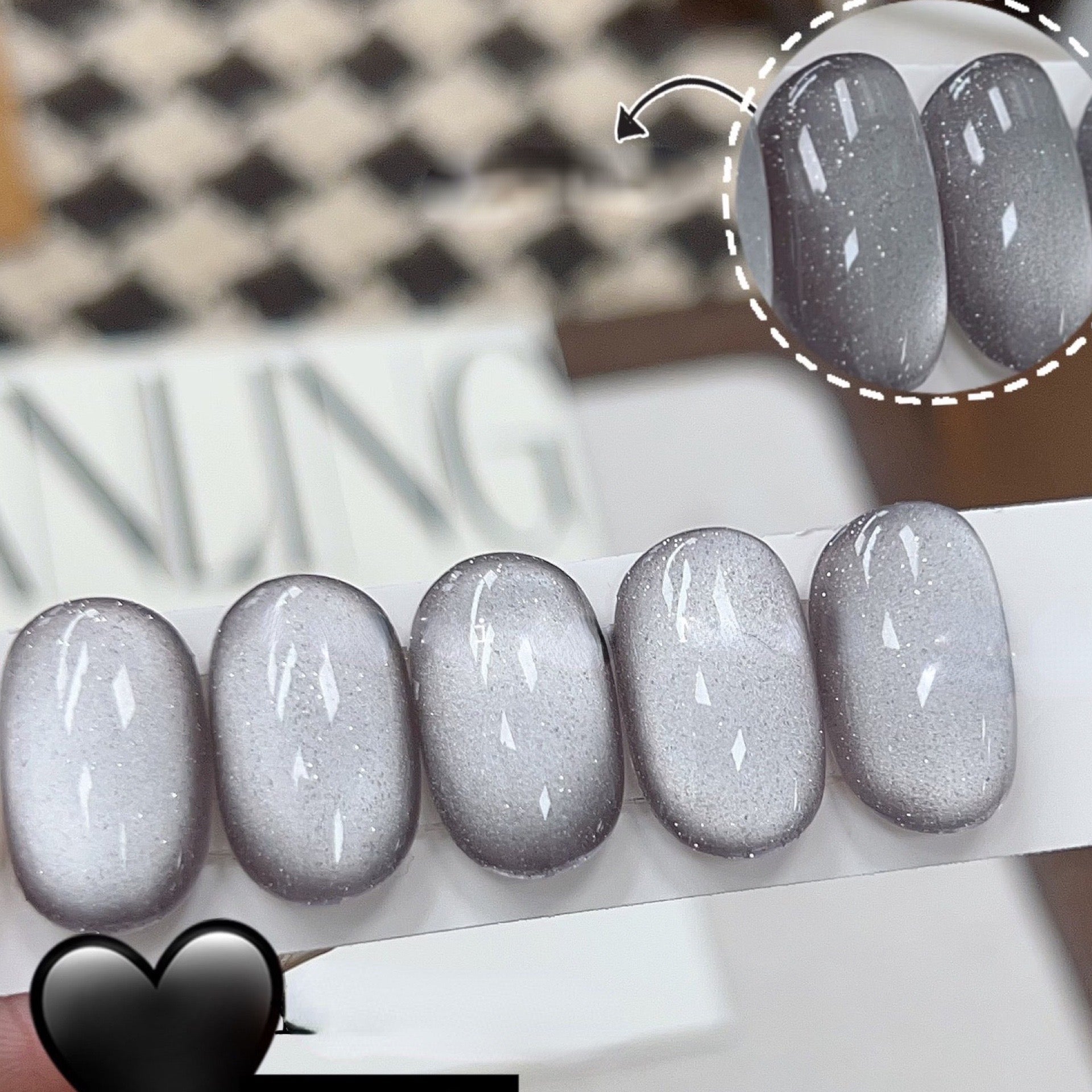 Storm magnetic cat eye gel polish creating a dramatic 3D nail effect with deep smoky shimmer and reflective particles, forming a mysterious glowing cat eye line across the nail for a bold professional gel manicure and striking reflective nail design.
